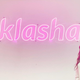 Klasha CEO Jessica Anuna poses for a photo with the Klasha logo behind her